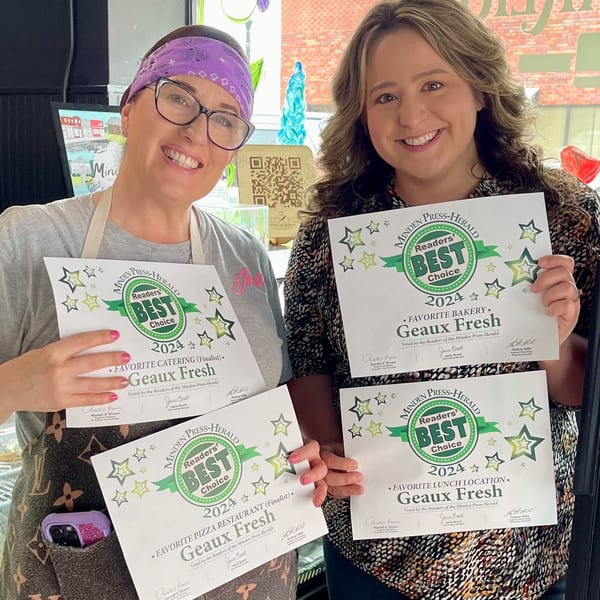Two smiling women from Geaux Fresh proudly display their "Readers' Best Choice 2024" awards.