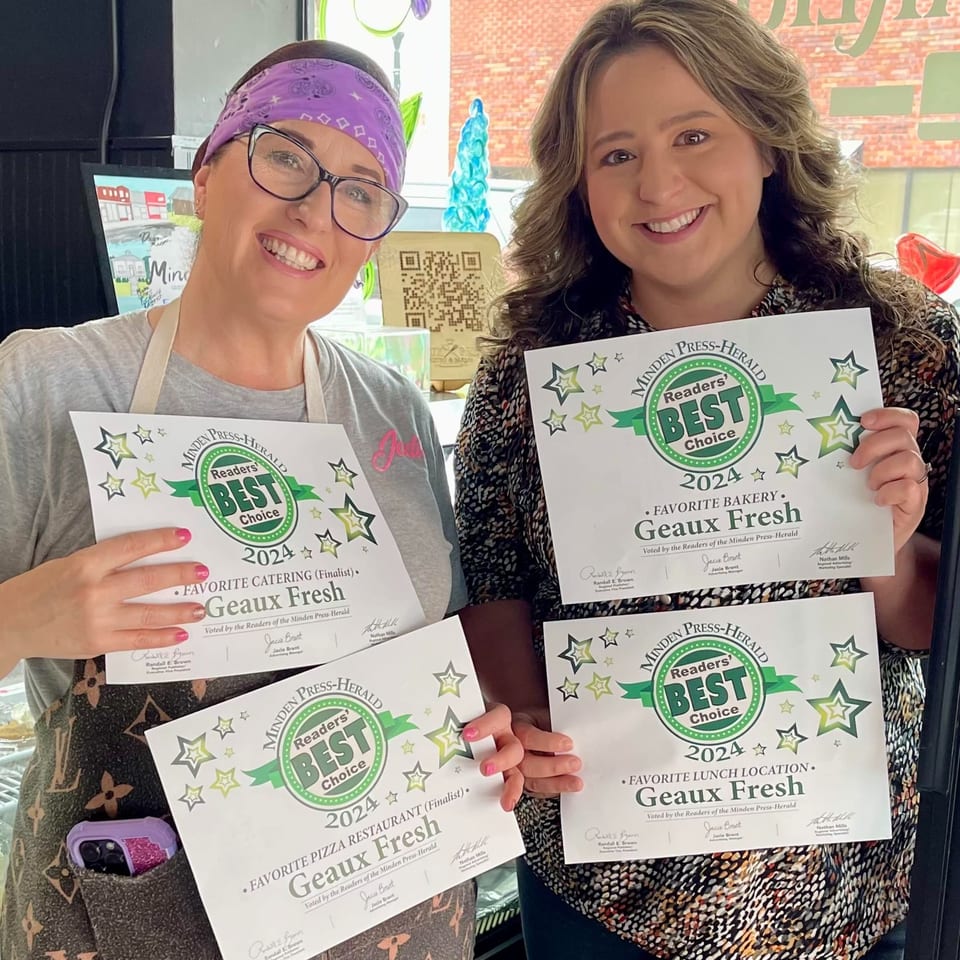 Two smiling women from Geaux Fresh proudly display their "Readers' Best Choice 2024" awards.